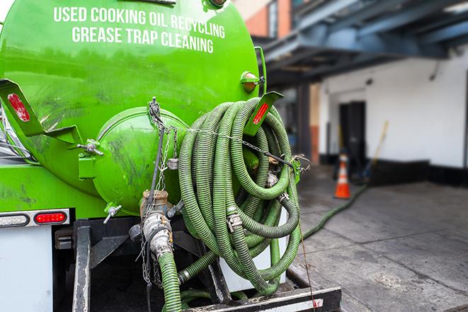 a technician pumping a grease trap in a commercial building in Country Club Hills, IL